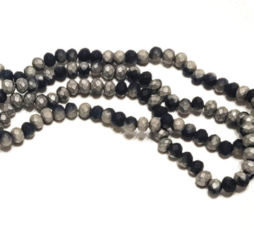 May include: A strand of faceted glass beads in a gradient of black and gray. The beads are round and have a matte finish.